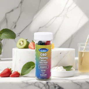 CBD Vegan Gummies Assorted 750MG bottle on marble counter with fresh fruit and tea